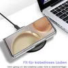 A clear phone case is shown on a wireless charger next to a laptop. Produktbild-Vorschau