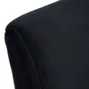 A close-up view of the corner of a black upholstered chair. Produktbild-Vorschau