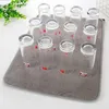 A collection of clear glasses arranged on a gray drying mat. Produktbild-Vorschau