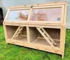 A wooden cage with a glass top sits on green grass. Produktbild-Vorschau