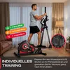 A man is using an elliptical trainer in a living room. Produktbild-Vorschau