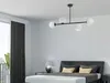 A bedroom with a modern chandelier over a bed. Produktbild-Vorschau
