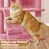 A ginger cat is climbing on a pink cat tree with text overlay. Produktbild-Vorschau