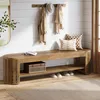 A wooden bench in an entryway with coats and a hat on a rack above it. Produktbild-Vorschau
