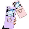 Two flip phone cases with ring stands, one purple and one pink, are displayed against a white background. Produktbild-Vorschau