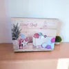 A close-up of an advent calendar with a Christmas theme, featuring yarn, a small tree, and decorative elements. Produktbild-Vorschau