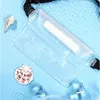 A clear waterproof bag is shown floating on blue water with shells and ice cubes. Náhled obrázku produktu