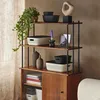 A shelf unit displaying various storage containers, vases, a plant, and decorative items. Produktbild-Vorschau
