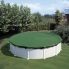 An above-ground swimming pool covered with a green winter cover, situated on a grassy lawn surrounded by trees and bushes. Produktbild-Vorschau