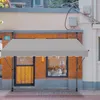 A gray awning is installed in front of a storefront. Náhľad obrázku produktu