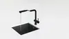 A black kitchen faucet with a pull-out spray head is shown over a black sink, with water running from the faucet. Podgląd zdjęcia produktu