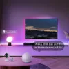 A living room scene with a TV, smart light bulb, and other smart home devices, showcasing voice control. Produktbild-Vorschau