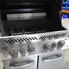 Close-up view of the front panel and interior of a grill. Produktbild-Vorschau