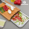 A bamboo cutting board with a built-in stainless steel tray filled with chopped vegetables. Náhľad obrázku produktu