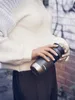 A person holding a Contigo travel mug outdoors. Náhľad obrázku produktu