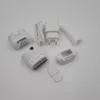 A collection of grooming accessories, including epilator heads, a shaver head, a cleaning brush, and a charger, laid out on a white background. Voir les images du produit