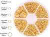 A circular container divided into six compartments, each filled with gold-colored jump rings of various sizes. Produktbild-Vorschau