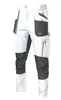 A pair of white and gray work pants with multiple pockets. Produktbild-Vorschau
