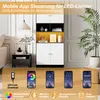 A tall white and black cabinet with yellow accents, featuring LED lights controlled by a mobile app. The image also shows four smartphone screens demonstrating app features. Produktbild-Vorschau