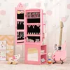 A pink jewelry cabinet for children, with a guitar and toys in the background. Podgląd zdjęcia produktu