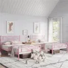 A bedroom with two pink metal beds, decorated with stuffed animals and blankets. Produktbild-Vorschau
