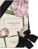 A box of Jo Malone Peony & Blush Suede Cologne, decorated with images of peonies and tied with a black ribbon and bow. Produktbild-Vorschau