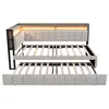 A bed frame with an extended trundle bed, both showing wooden slats. The main bed has a padded headboard and a built-in LED light strip. Náhled obrázku produktu