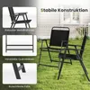Two black folding garden chairs are set up on a green lawn in front of a white house. Náhľad obrázku produktu