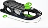 A black and green plastic sled with a steering wheel and a tow rope, isolated on a white background. Podgląd zdjęcia produktu