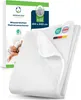 A white mattress protector is folded and displayed next to its packaging, which features an image of an elderly couple sleeping peacefully in bed. The packaging also includes product specifications and certification logos. Produktbild-Vorschau