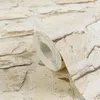 A close-up view of a roll of wallpaper with a stone pattern. Produktbild-Vorschau