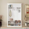 A white hall tree with shelves and hooks, displaying shoes, bags, and a hat. Náhľad obrázku produktu