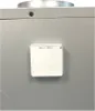 A close-up view of a white digital thermostat mounted on a gray metallic surface. Produktbild-Vorschau