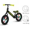 A black balance bike with yellow handlebars and a patterned seat, shown on a white background with informational graphics on the right. Produktbild-Vorschau