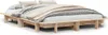 A wooden bed frame with bedding and pillows, shown from a slightly elevated side angle against a white background. Produktbild-Vorschau