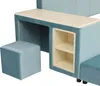 A close-up view of a blue upholstered desk with a light wood-colored top and two open shelves. A matching blue stool is visible to the left. Voir les images du produit