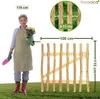 A woman gardener holding a potted plant stands next to a wooden garden gate with size dimensions indicated. Náhled obrázku produktu