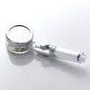 A close-up studio shot of a chrome and clear plastic shower head with a filter inside. Produktbild-Vorschau