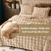 A close-up view of a fluffy, textured blanket on a bed, with a magnified section showing the thickness of the material. Náhled obrázku produktu