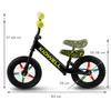 A black balance bike with yellow handlebars and seat, featuring colorful LED lights on the wheels. Dimensions are indicated with measurement lines and text. Produktbild-Vorschau