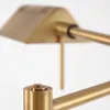 A close-up of a brass lamp's joint and switch. Produktbild-Vorschau