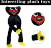 A collage of a black plush toy with yellow hands and feet, and close-ups of its face and hand. Produktbild-Vorschau