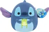 A plush toy of Stitch from Disney's Lilo & Stitch, holding a green frog. Voir les images du produit