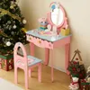 A child's pink vanity table and chair set with rainbow decorations, placed next to a decorated Christmas tree and gift boxes. Podgląd zdjęcia produktu