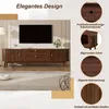 A TV stand with a television on top, presented in a room setting with decorative elements and close-up feature callouts. Voir les images du produit