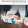 A person is working at a desk with a phone case on a table. Produktbild-Vorschau