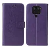 A purple flip phone case with a floral and butterfly embossed design is shown open, displaying the inside and outside of the case. Produktbild-Vorschau