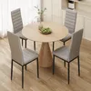 A round wooden dining table with four gray chairs in a well-lit room. Náhľad obrázku produktu
