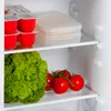 Interior of a refrigerator with food items on shelves. Voir les images du produit