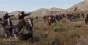 A group of mounted warriors in a field, some with bows drawn. Produktbild-Vorschau